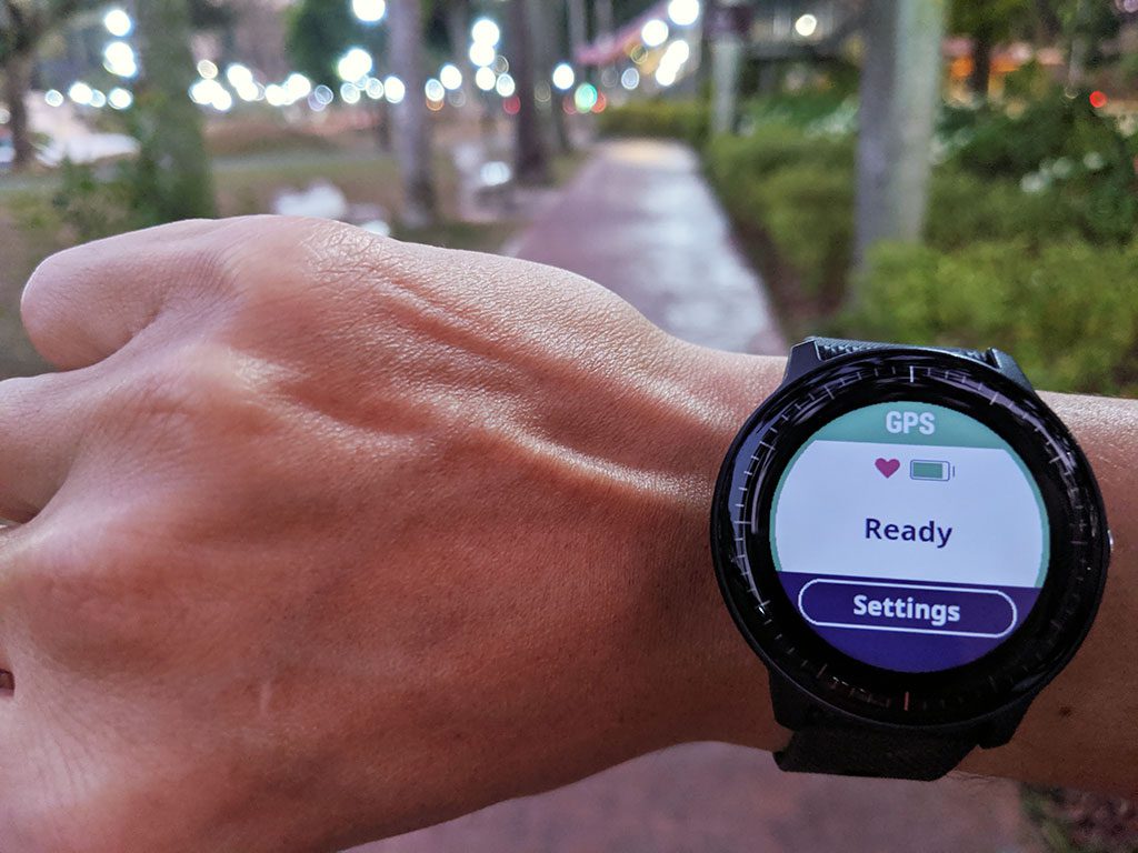 The circular watch face of the Garmin Vivoactive 3 Music, starting an activity