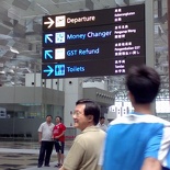 littered along the terminal are large multi-coloured, multi-lingual sign boards