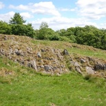 The full rock face in the distance