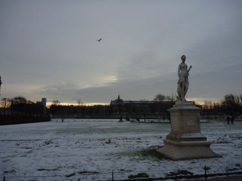 flanked by many sculptures decorating the garden