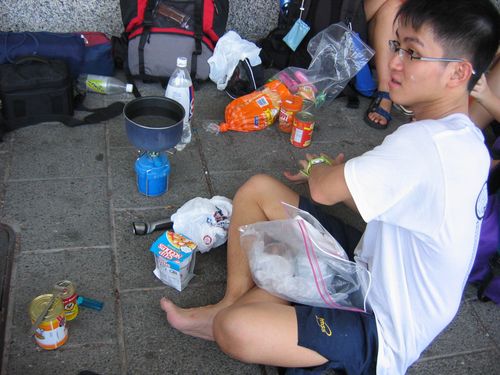 the bunsen burner beats lighting soild fuel to cook in front of an MRT station!