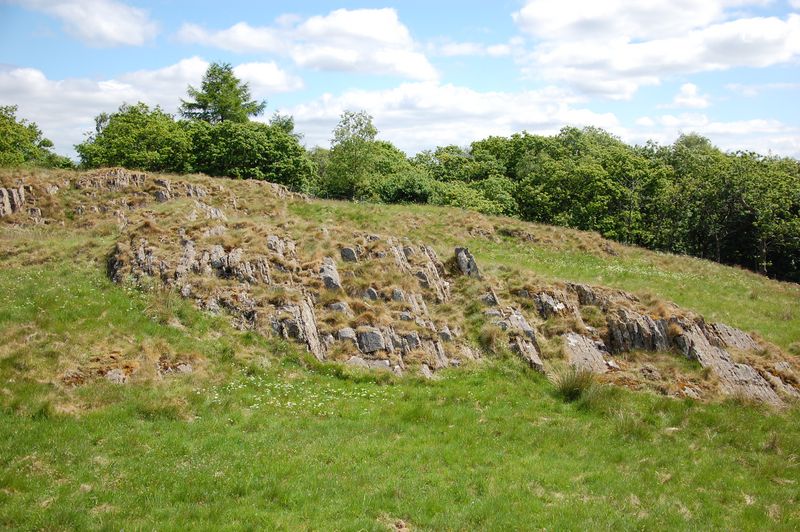 The full rock face in the distance