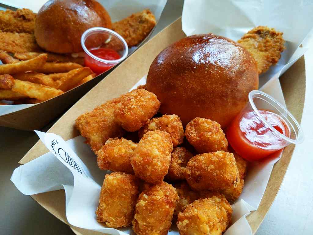 Your burgers are served on disposable cardboard trays with wax paper.