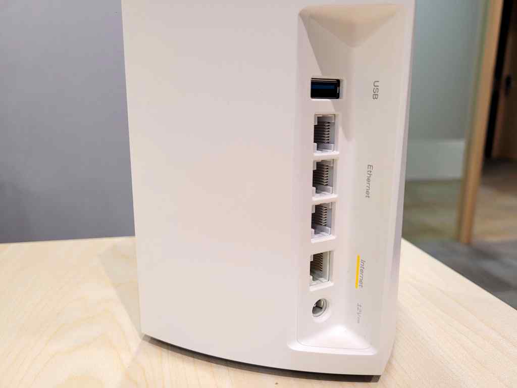 The rear IO of the MX4200 Mesh Router, discreetly tucked at the rear back of the device