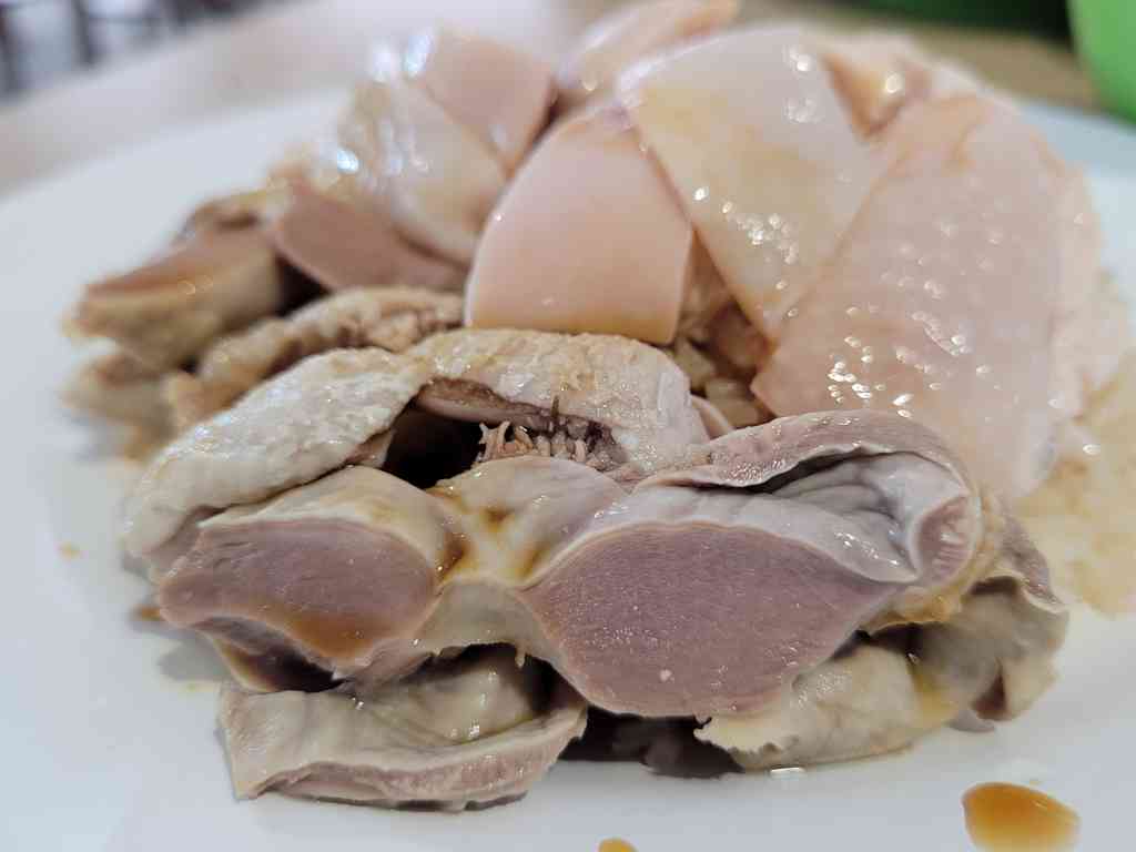 Chicken rice dish with sides of chicken gizzards